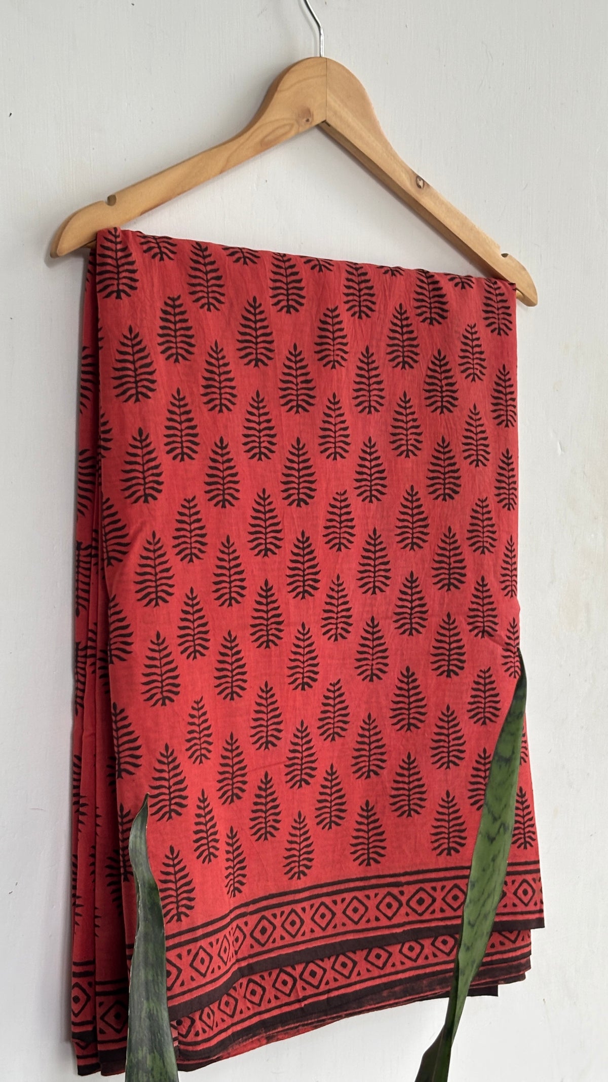 Coral Red and Black Leaf Print Mul Cotton Saree with Black Geometric Border